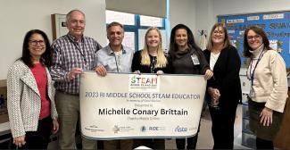 From left to right: RI STEAM Center Director Dr. Lisa Bain, Chariho Middle School Computer Science Teacher and Content Leader for Unified Arts Bryan Lucas, Chariho Middle School Principal Gregory Zenion, Michelle Conary Brittain, Chariho Regional School District STEM Specialist Susie Scanapieco, Chariho Middle School Assistant Principal of Teaching and Learning Mary Beth Florenz, and RIDE STEM Specialist Carolyn Higgins (Image Courtesy Chariho Regional School District).