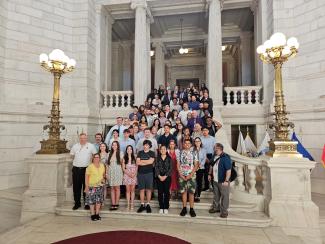 A group of students standing on marble steps