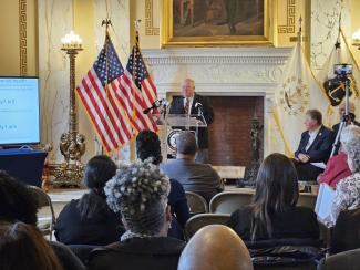 A man standing at a podium in front of a crowd.
