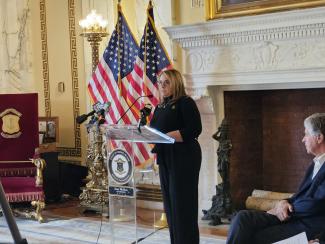 A woman standing at a podium. 