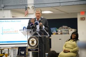 Governor McKee stands at a podium for Math Matters RI